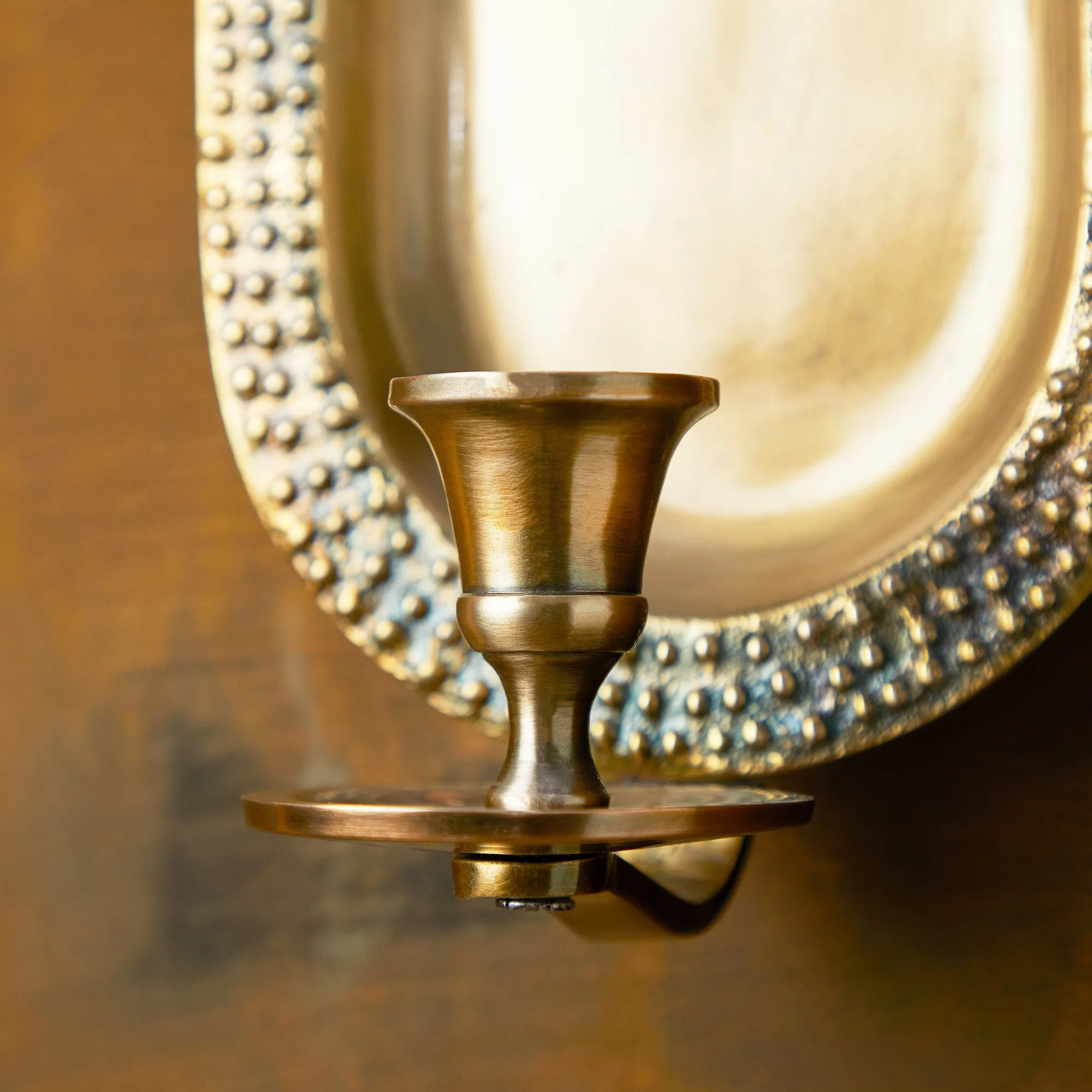 Beacon wall mounted candle holder in antiqued brass